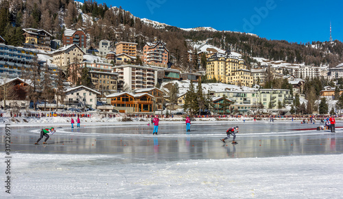 Winter skate sprint race athlete. Speed skater on lake. photo