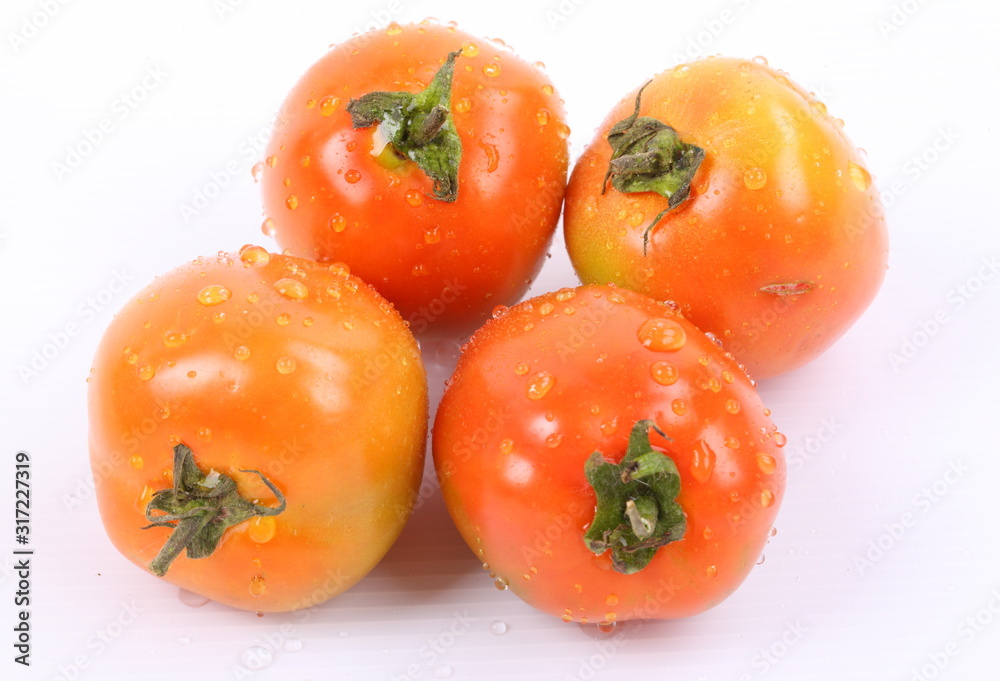 Tomatoes with water drops isolated on white background Tomatoes with water drops isolated on white background