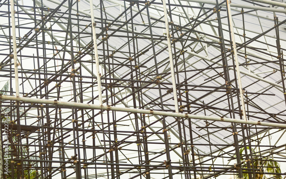 workers are installing scaffolding for home construction and industrial applications workers are installing scaffolding for home construction and industrial applications