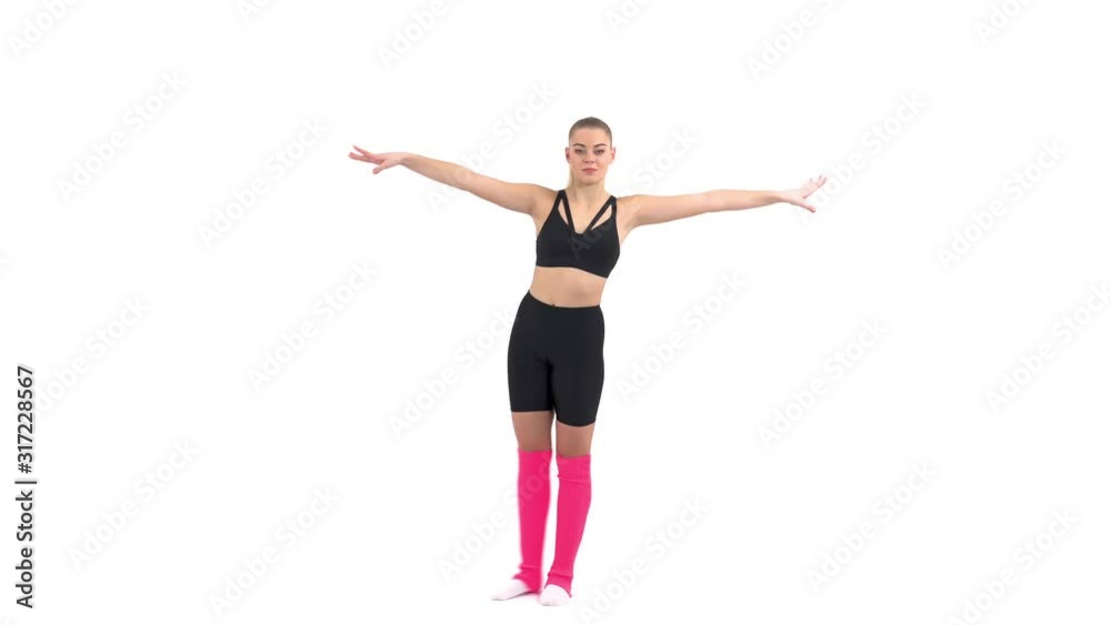 Young female gymnast performing gymnastic exercises (Grand battement to the side). Young female gymnast performing gymnastic exercises (Grand battement to the side).