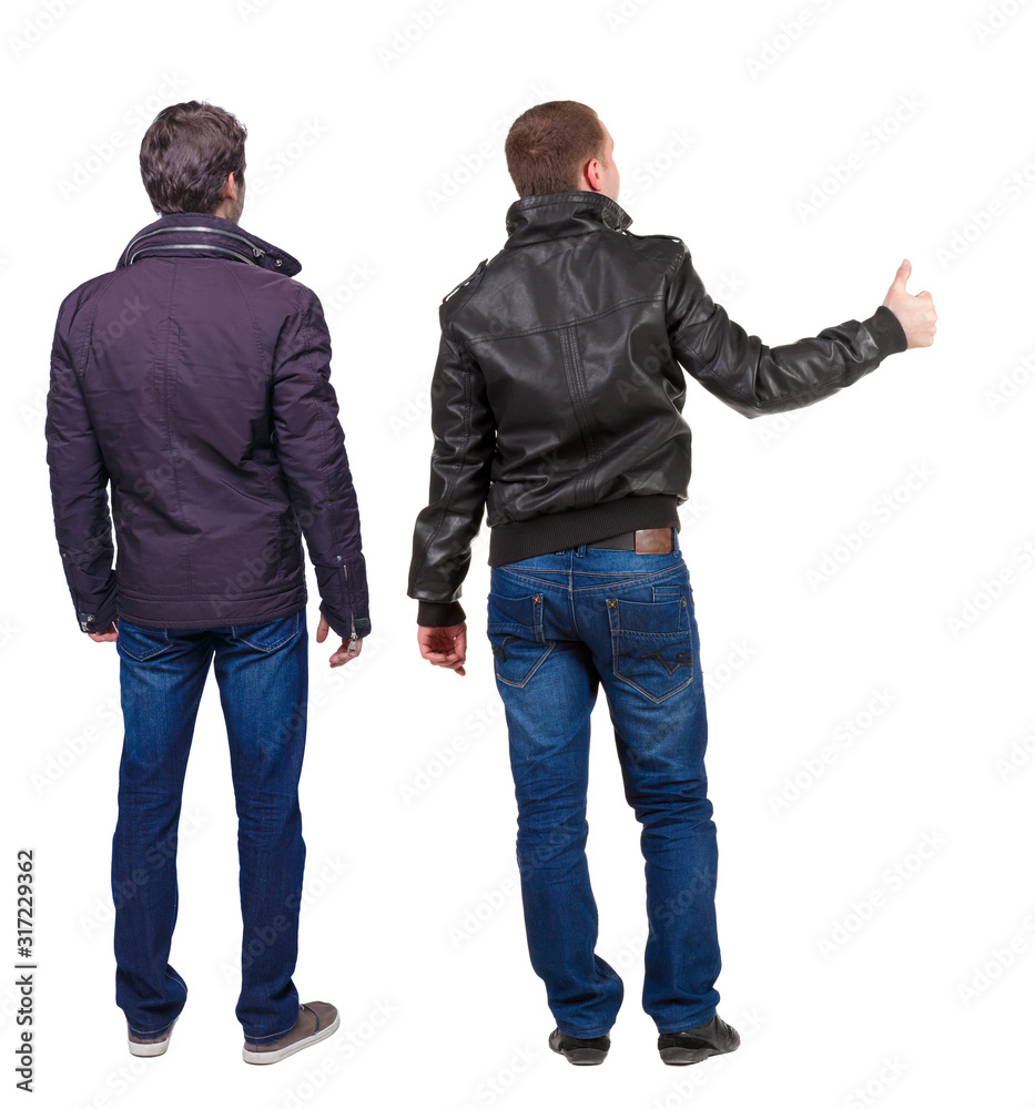 Back view of two man in winter jacket showing thumb up. Back view of two man in winter jacket showing thumb up.