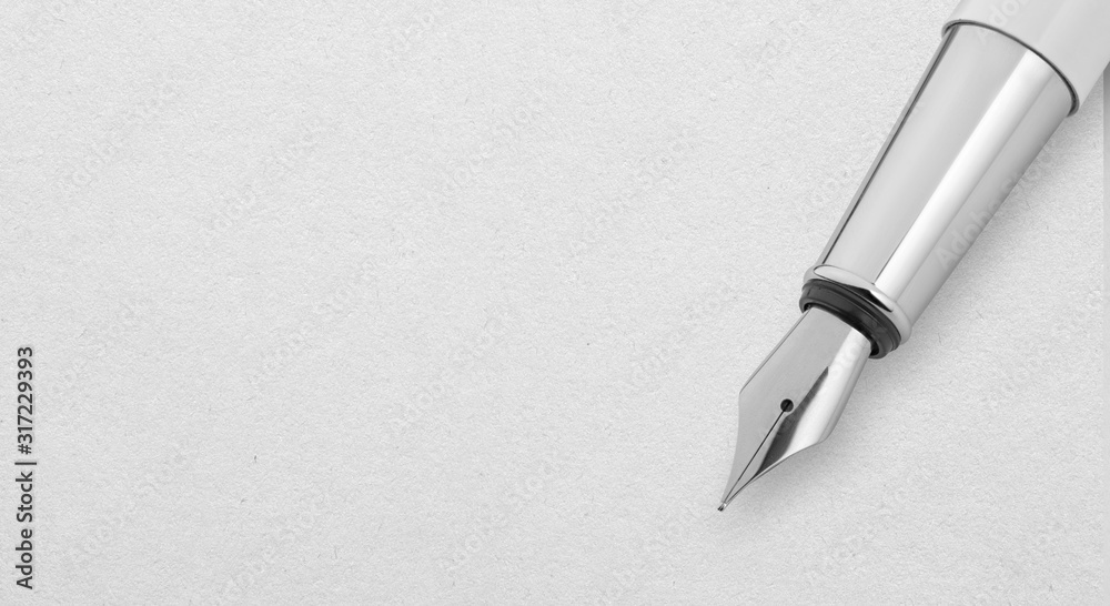 Silver Fountain Pen on a white paper sheet with copy space Silver Fountain Pen on a white paper sheet with copy space