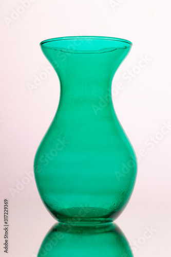 green glass vase on a white background.