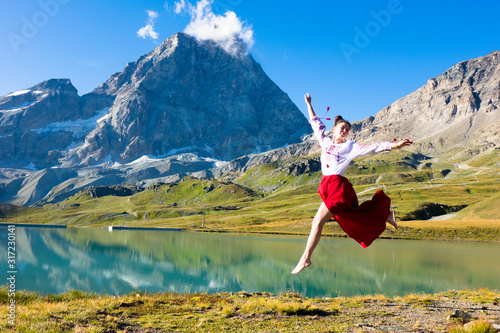 Young girl dancing in the mountains