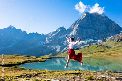 Young girl dancing in the mountains