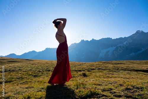 Young girl dancing in the mountains