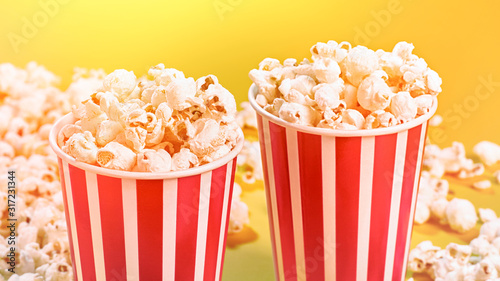 Closeup of two red paper baskets with popcorn