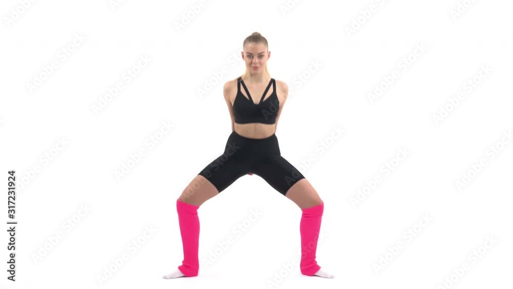 Strong and fit woman is doing squat exercises. Sport concept. Isolated, on white background Strong and fit woman is doing squat exercises. Sport concept. Isolated, on white background