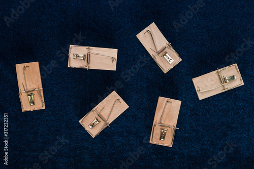 top view of wooden mousetraps on blue background photo