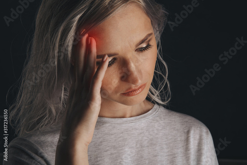 Woman in stress with pain on her face feeling headache