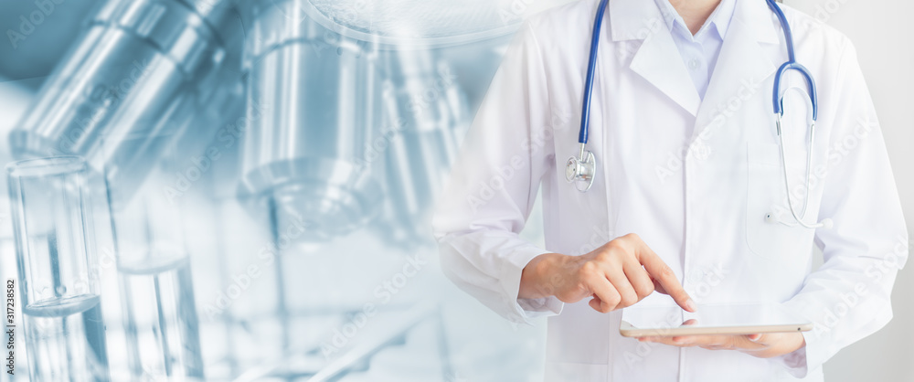 Medical technology concept .The doctor using tablet in hand and the with liquid to test tube and laboratory, medical and medical services Medical technology concept .The doctor using tablet in hand and the with liquid to test tube and laboratory, medical and medical services