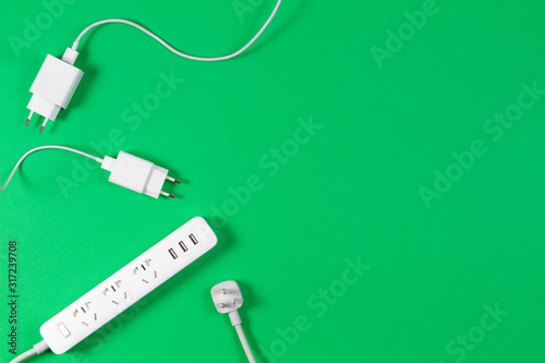 White extension cord and cables on light green background