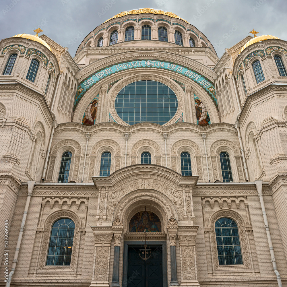 Front view of a fragment of the facade of the Naval Cathedral in Kronstadt, Russia against a gray autumn sky