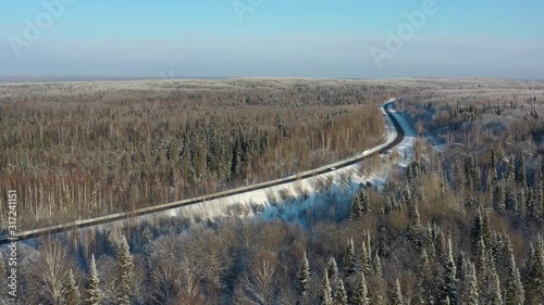 Aerial video view of winter road in taiga on Salair Ridge in winter photo