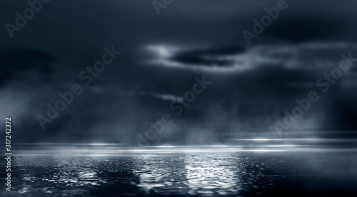 Dramatic black and white background. Cloudy night sky  moonlight  reflection on the pavement. Smoke and fog on a dark street at night.