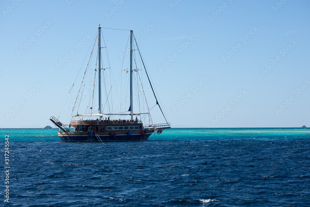 Big ship with masts sailing in the Red Sea