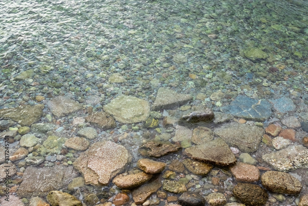Abstract marine background with water covering stones and pebbles. Sea calm Abstract marine background with water covering stones and pebbles. Sea calm