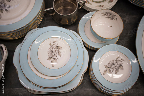 the multicolored tea and dining sets at a flea market for sale photo