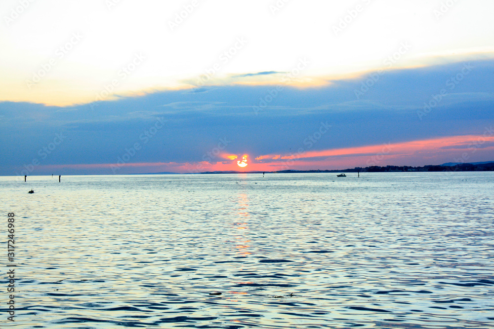 Sunset with red sun on the lake in Bregenz, Austria.