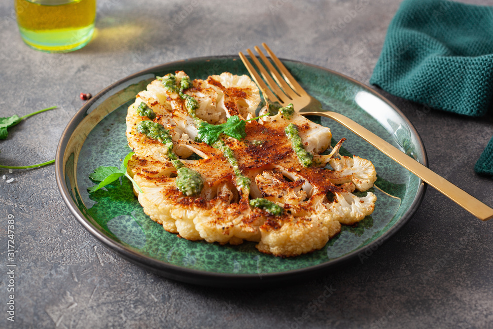 cauliflower steaks with herb sauce and spice. plant based meat substitute cauliflower steaks with herb sauce and spice. plant based meat substitute