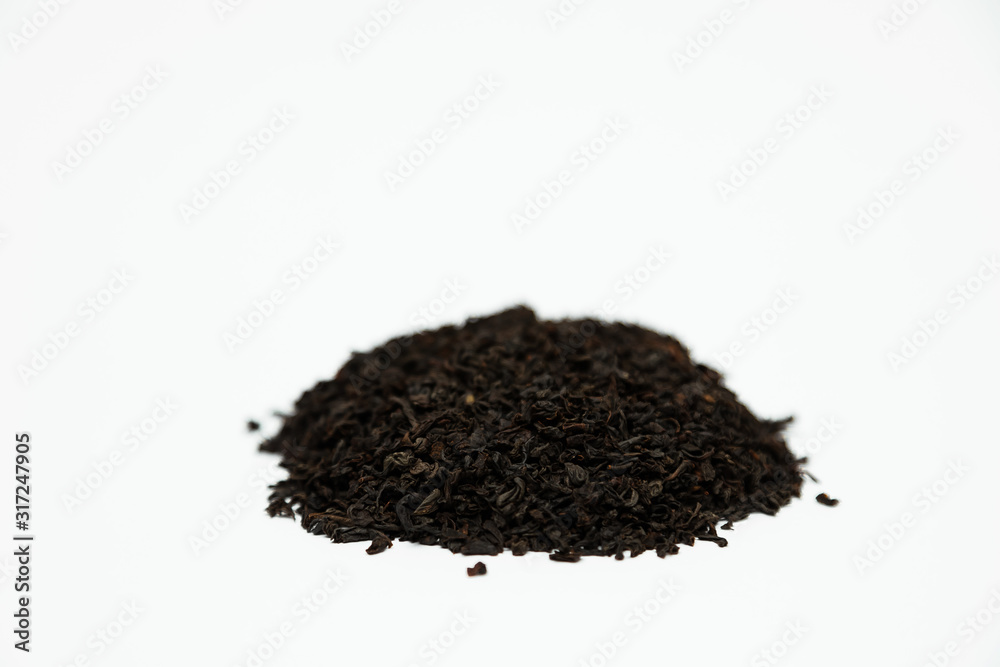 a handful of dried tea leaves sprinkled with a slide on a white background a handful of dried tea leaves sprinkled with a slide on a white background