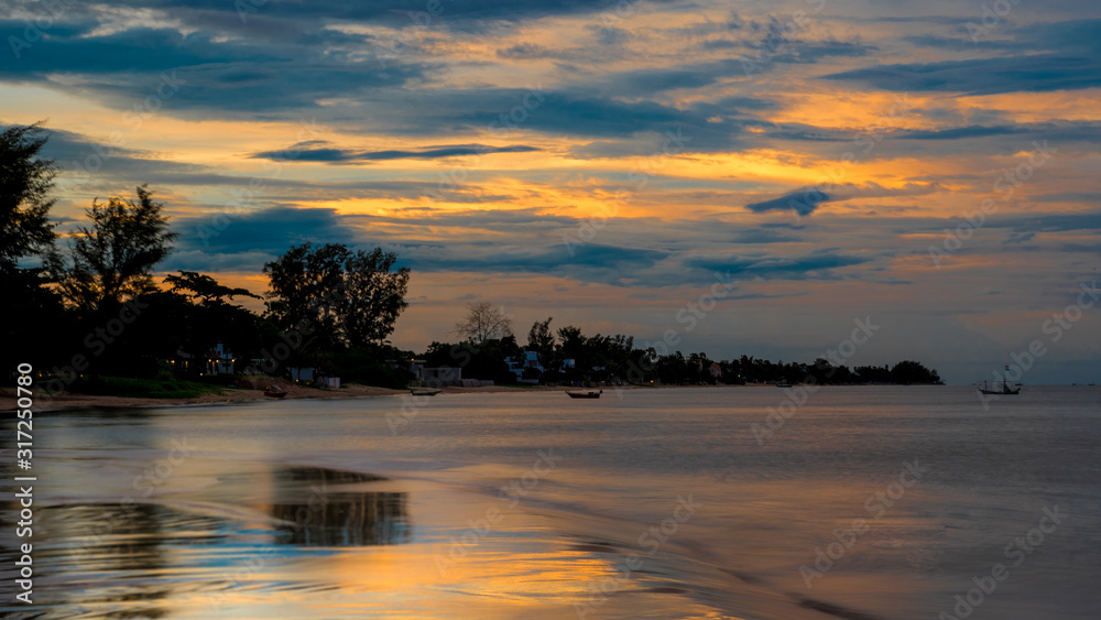 Reflection of coastline of Pak Nam Pran at dusk in Thailand