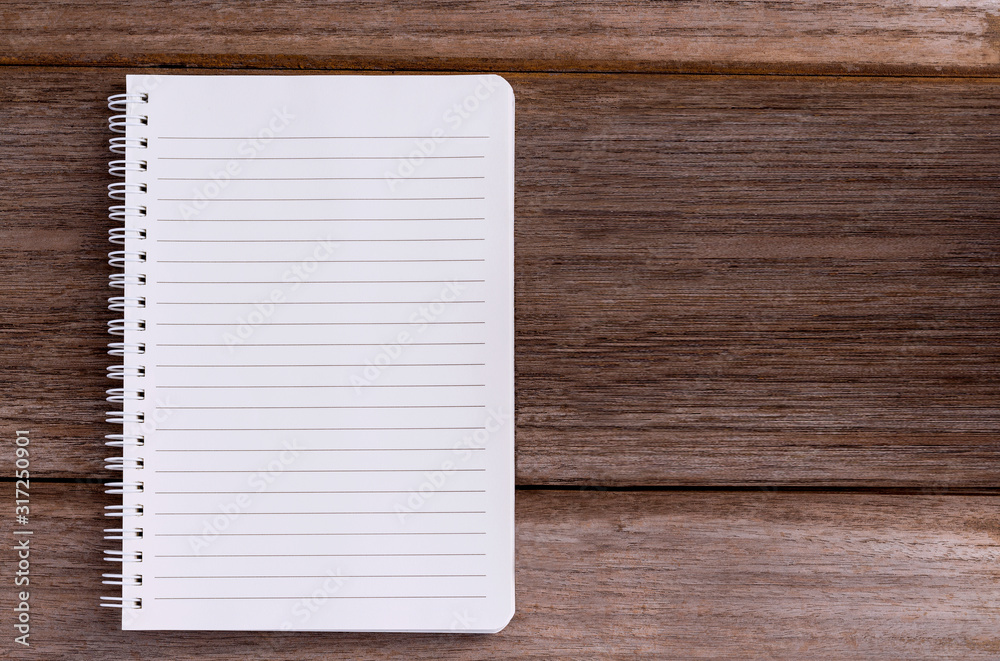 Blank notebook isolated on wood table background with copy space for your text or image. Blank notebook isolated on wood table background with copy space for your text or image.