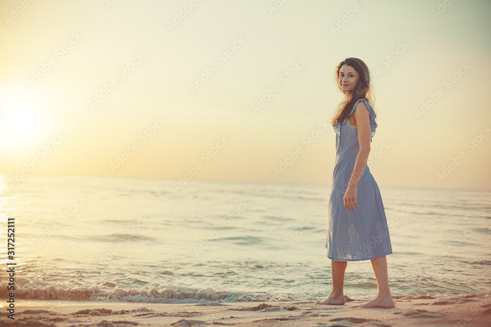 Young woman walking on a sandy beach. Phu Quoc island, Vietnam Young woman walking on a sandy beach. Phu Quoc island, Vietnam