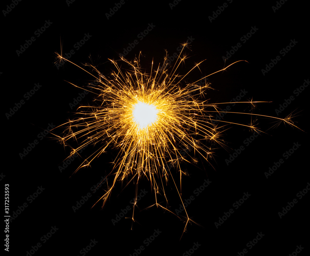 New Year or Christmas bengal fire, sparkler fireworks candle isolated on a black background. Party dark backdrop.