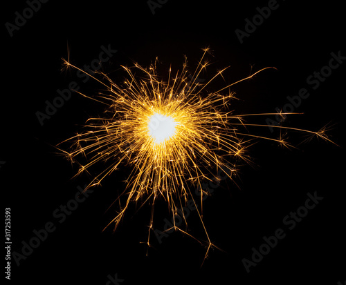 New Year or Christmas bengal fire  sparkler fireworks candle isolated on a black background. Party dark backdrop.