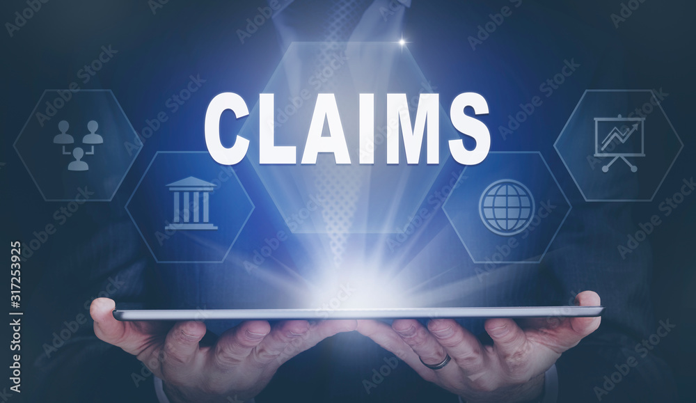Businessman holding a computer tablet display projecting a Claims concept.