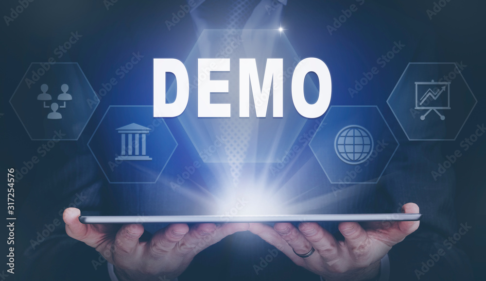 Businessman holding a computer tablet display projecting a Demo concept.