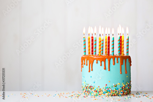 Birthday cake with candles and drip icing photo