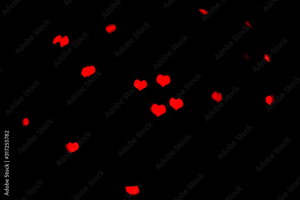 Blurred red lights in beautiful shape of the hearts on black background. Blurred red lights in beautiful shape of the hearts on black background.