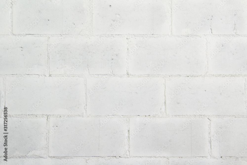 Naklejka premium White wall made of large painted brick.