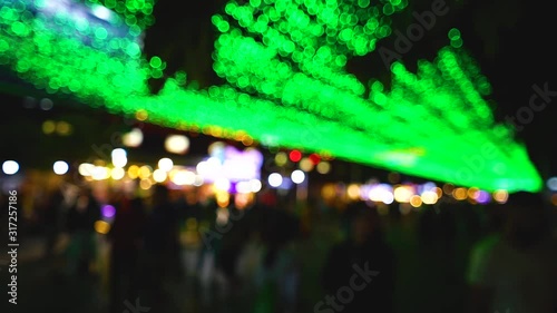 Beautiful blurry effect of green light in the city at night. photo