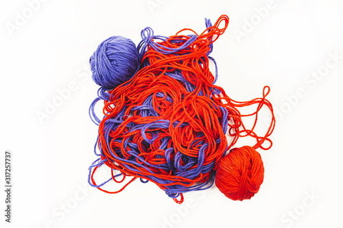 bright red and blue tangled threads on a white background photo