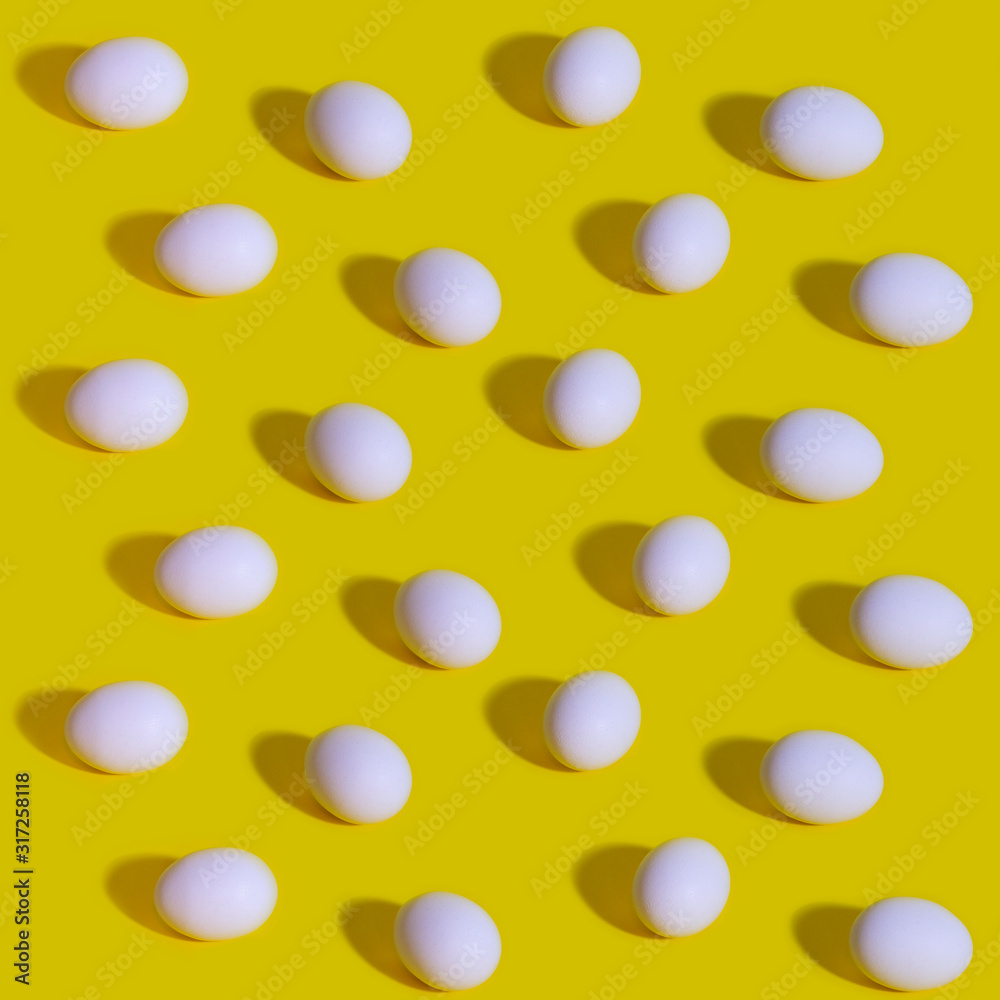 Pattern of white eggs on a pastel yellow background. Easter template