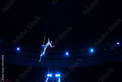 handsome acrobat performing in arena of circus © LIGHTFIELD STUDIOS