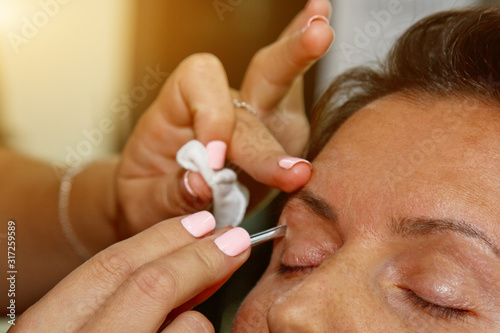 Beauty Woman Makeup. Closeup Of Beautiful Glamorous Sexy Woman Face With Smooth Skin Plucked Eyebrows And Metal Tweezers. Young Female Model Shaping Brows. Beauty And Skin care. High Resolution.