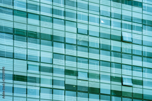 Modern apartment buildings in new neighborhood. Glass blue square Windows of facade modern city business building skyscraper. Windows of a building  texture.