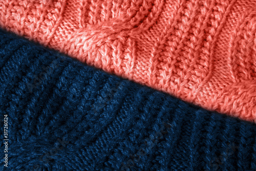 Stylish knitted fabrics of sweaters coral and classic blue color with a pattern.