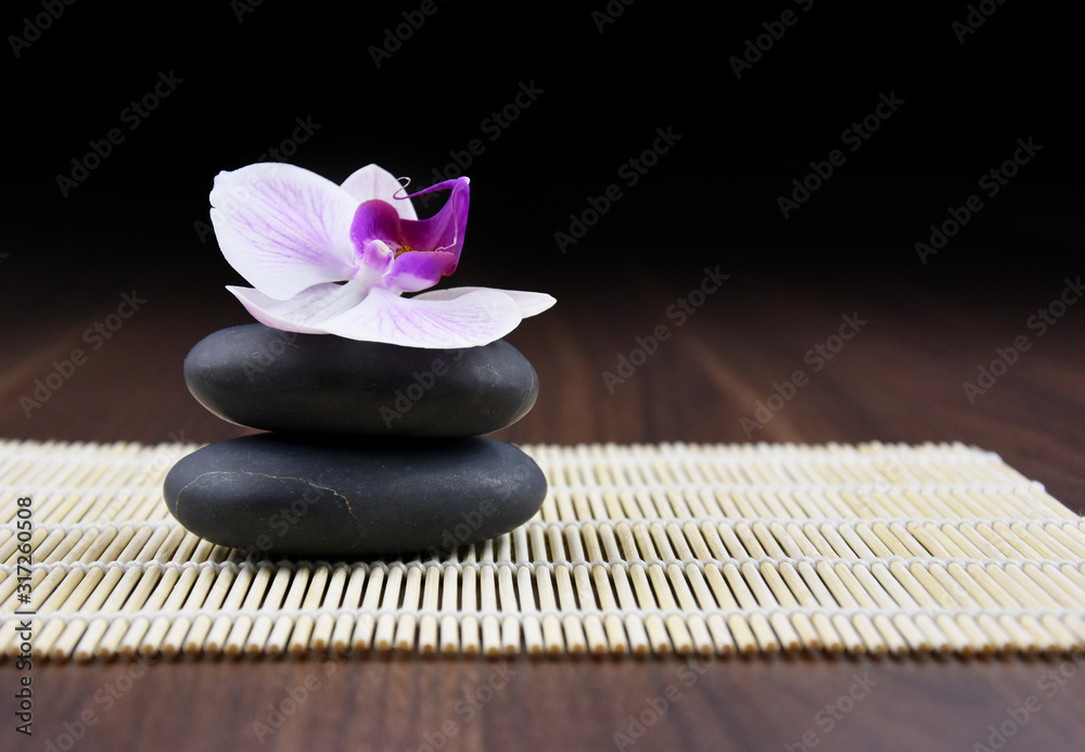 Massage stones with orchid stock images. Spa and wellness setting stock images. Pile of black stones. Black stones on a wooden background. Spa-concept with zen stones and orchid flower stock images Massage stones with orchid stock images. Spa and wellness setting stock images. Pile of black stones. Black stones on a wooden background. Spa-concept with zen stones and orchid flower stock images