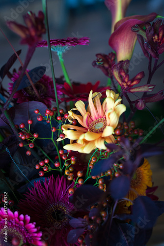 close up of a yellow gerbera flower in a bouquet