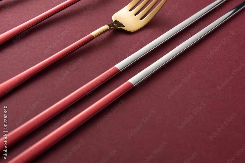 The exquisite tableware, knives, forks and plates used by the royal family are placed on the red background The exquisite tableware, knives, forks and plates used by the royal family are placed on the red background