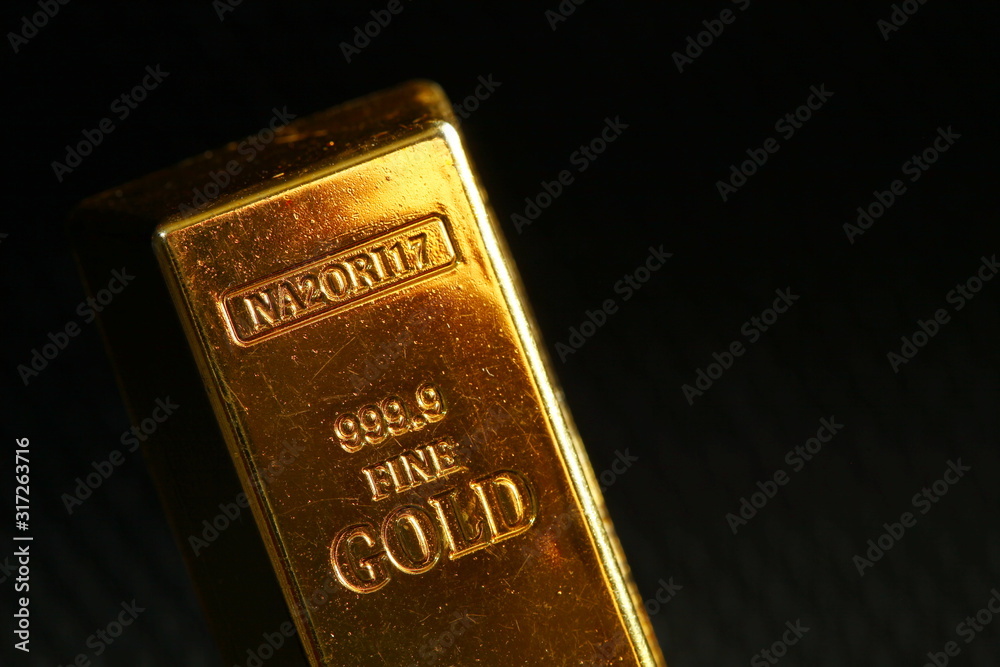 Plastic made gold bar style use for toy and game purpose put on dark background scene. Plastic made gold bar style use for toy and game purpose put on dark background scene.
