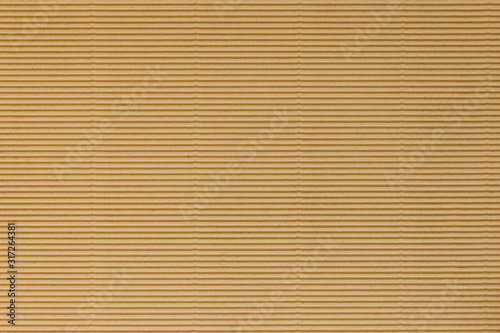 Brown corrugated Board with a horizontal texture for packaging. Striped background made of cardboard