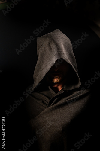 Portrait of a courageous warrior wanderer in a black cloak. Historical fantasy. Halloween