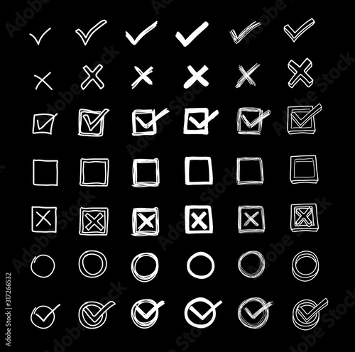 Checkmarks set and checkboxes hand drawn in a doodled style on chalkboard. Checklist and examination marks collection