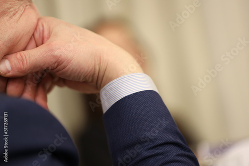 man leans on his hand  thinks or listens carefully